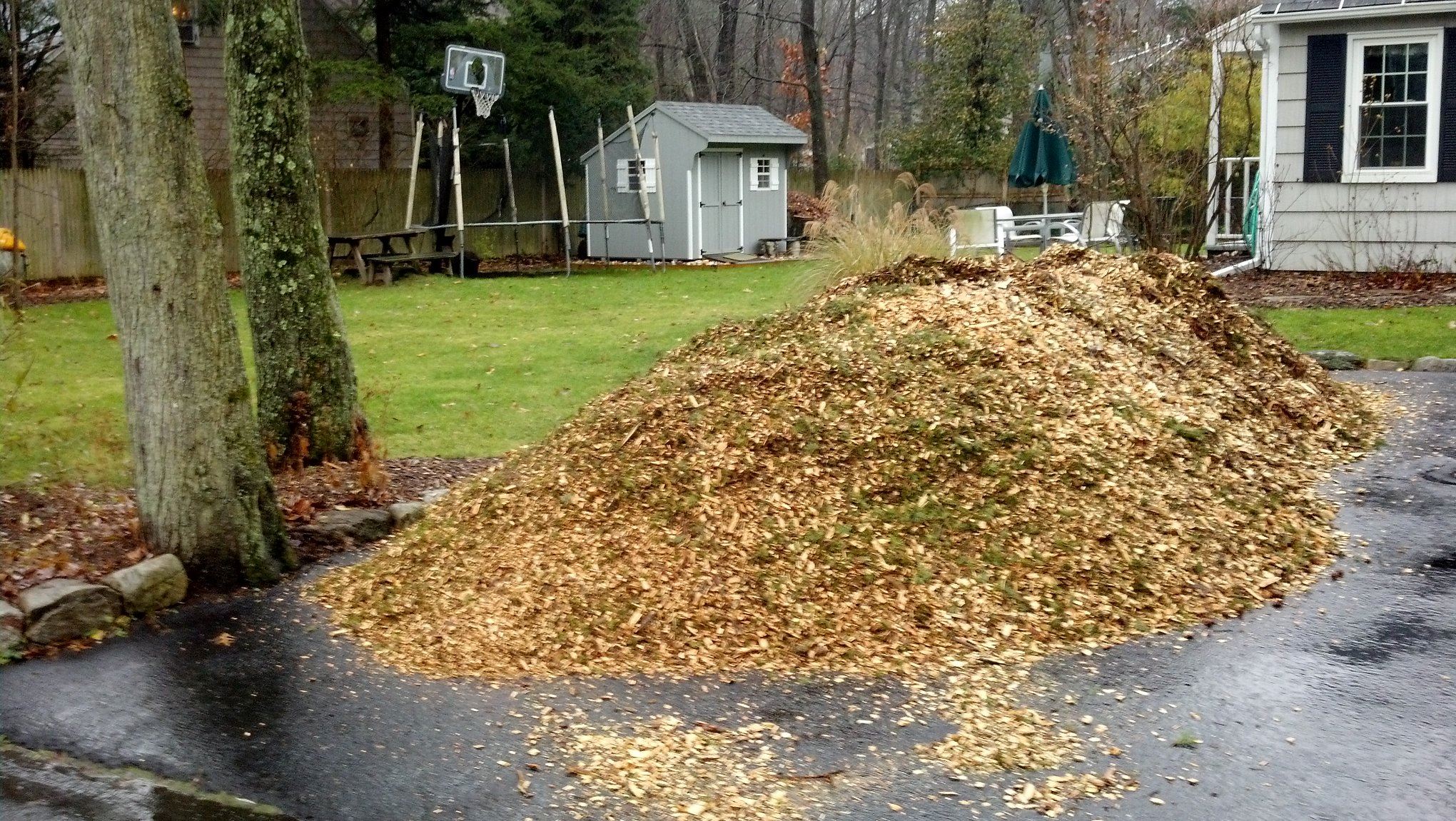 A pile of wood chips in home driveway
